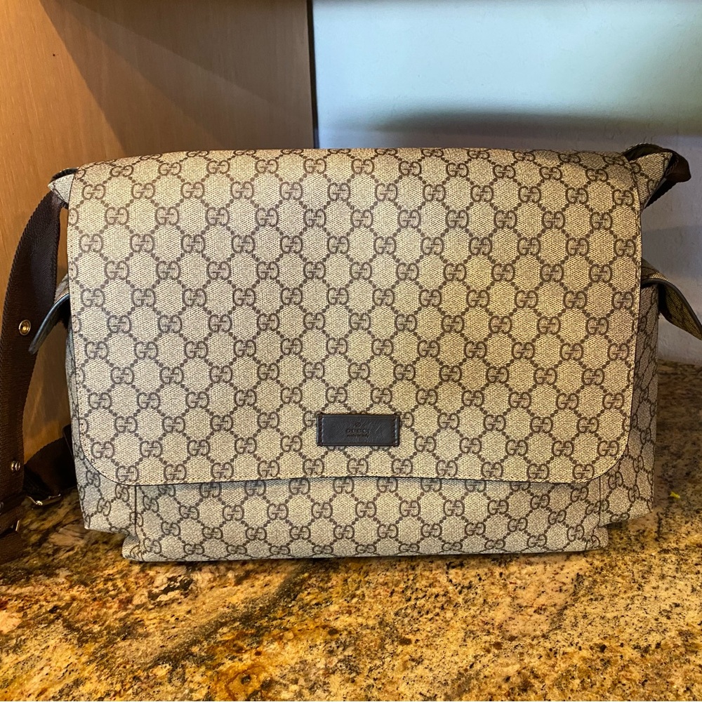 GG Supreme canvas diaper bag, designed with multiple pockets